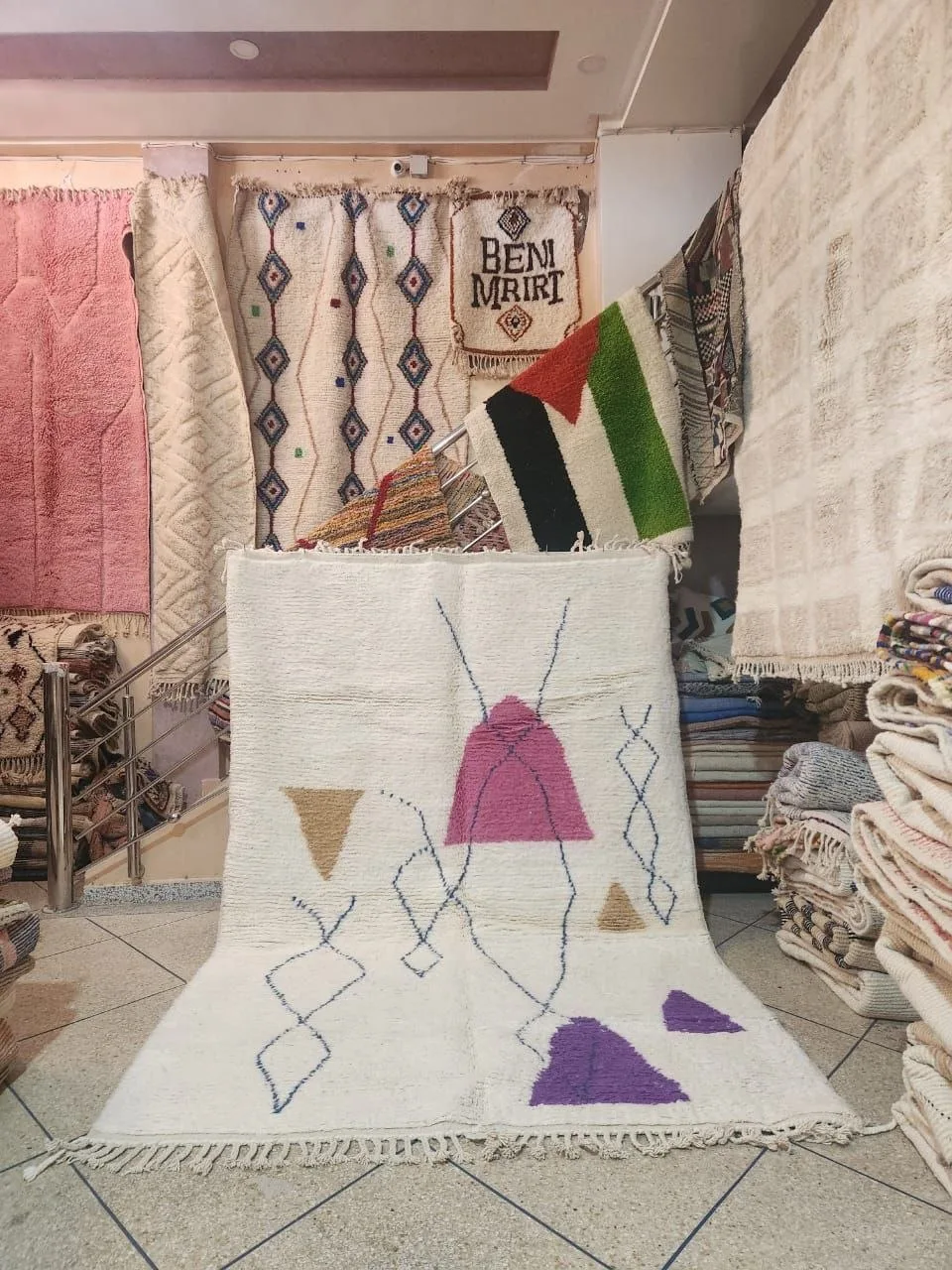 White Moroccan rug with pink and purple abstract geometric motifs
