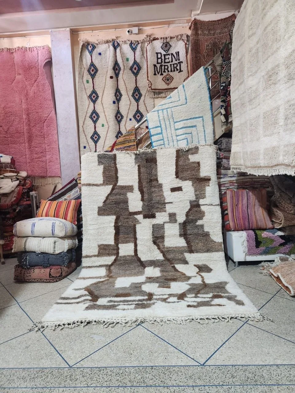 Ivory Beni Ourain rug with brown Amazigh figures and geometric marks