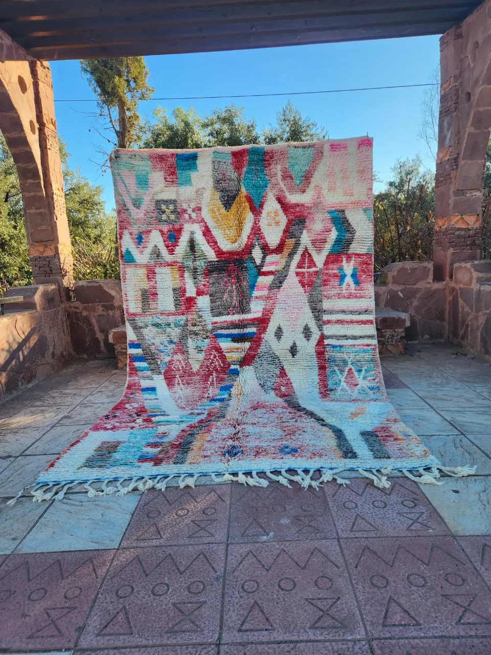 Colourful vintage Moroccan rug in terracotta archway