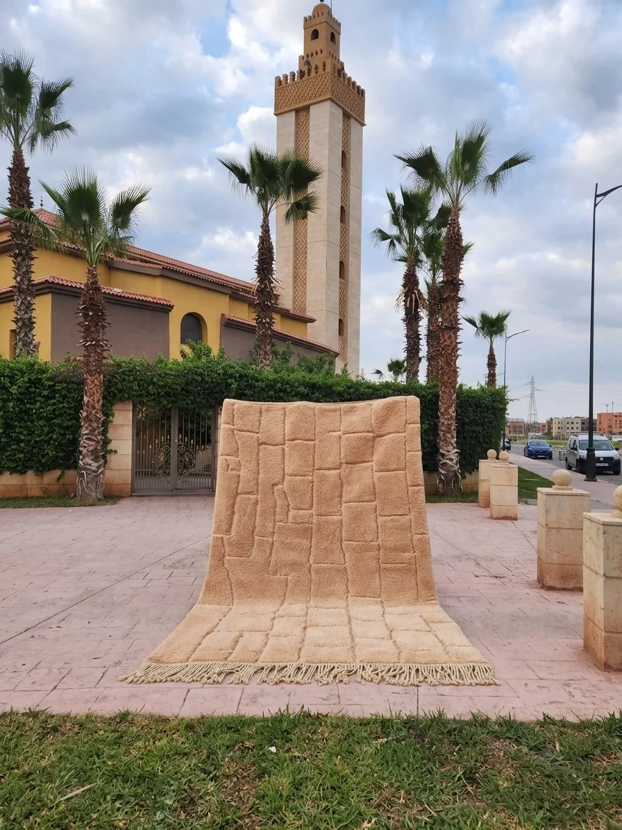 Moroccan rug in front of a mosque with palm trees
