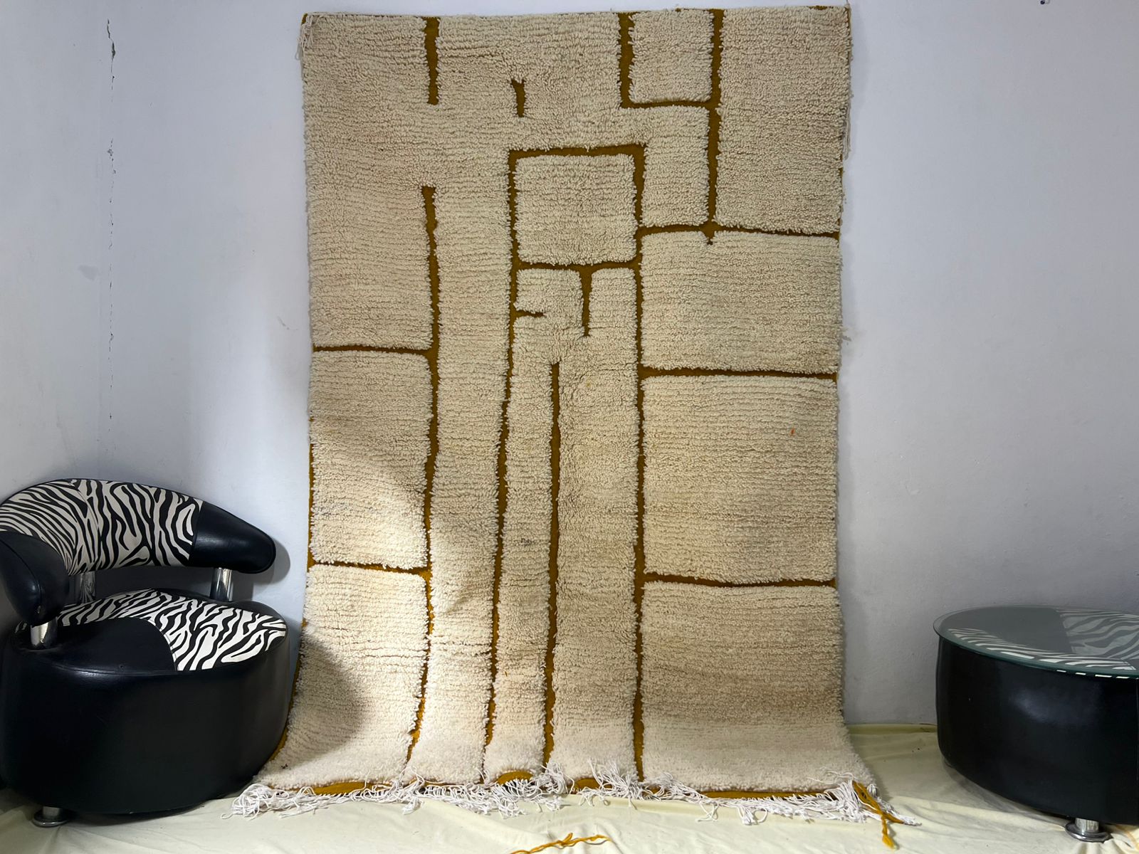 Contemporary hand-knotted rug in ivory and warm amber with bold abstract rectangular grid