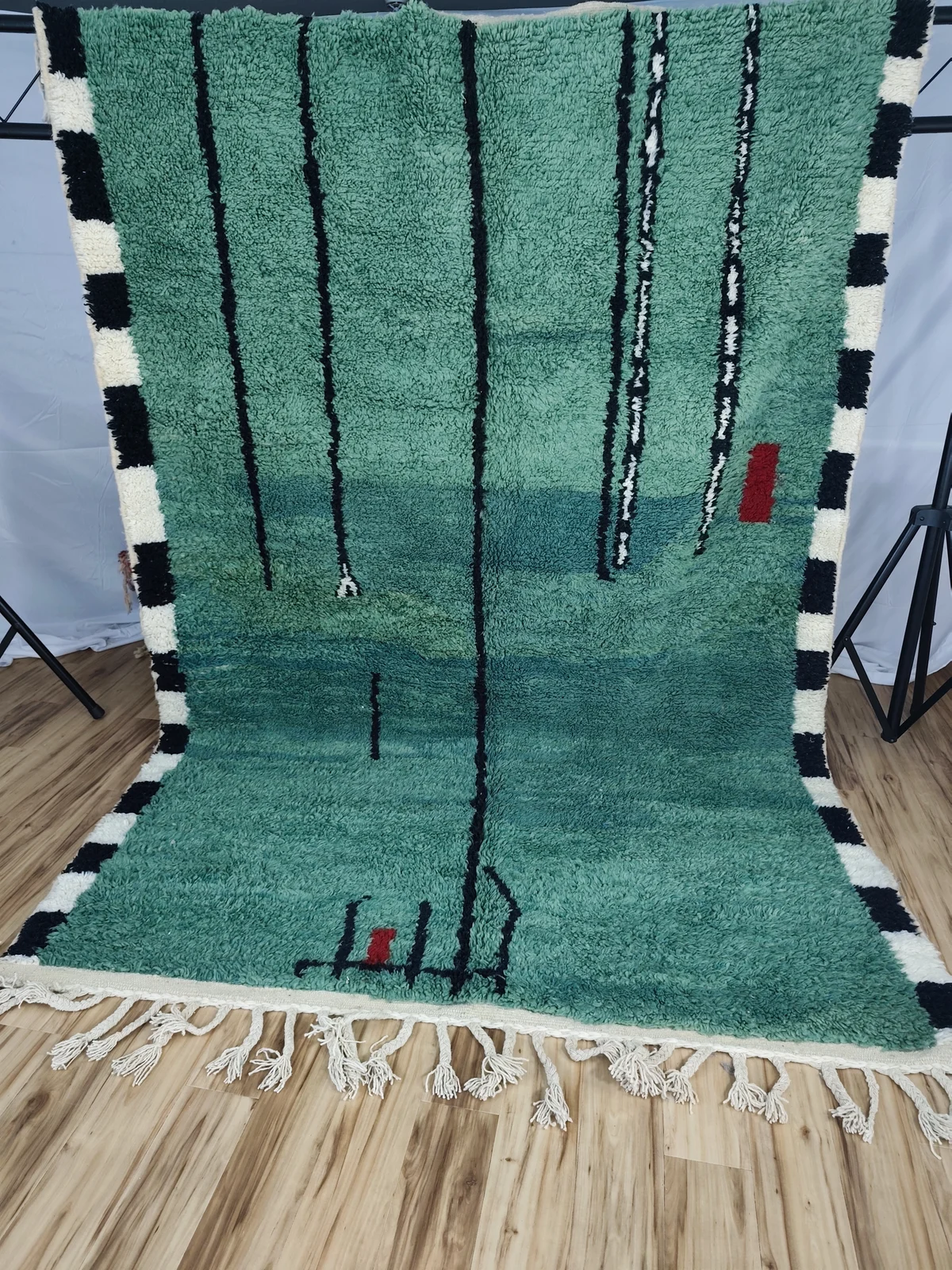 Contemporary Moroccan rug in green wool with graphic black and red lines