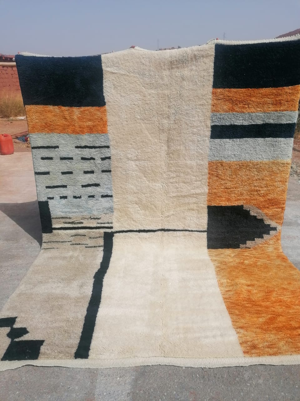 Large contemporary Moroccan rug with bold asymmetric panels of black, amber orange and slate blue on ivory