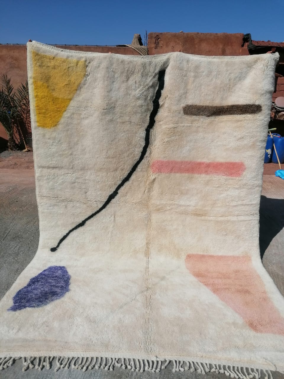 Ivory Moroccan rug with scattered abstract shapes in yellow, purple, pink and black