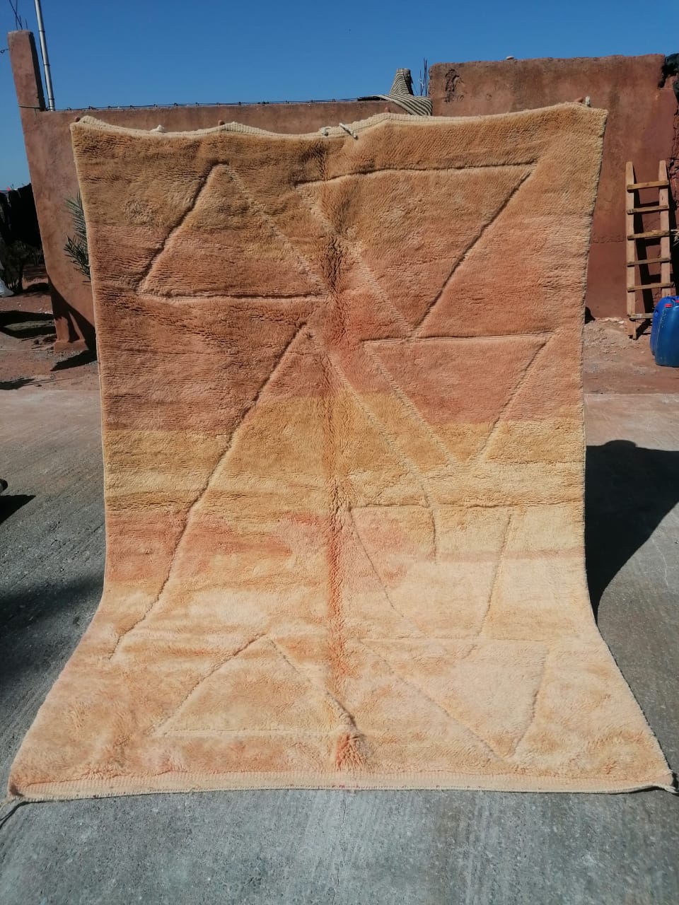 Tonal peach and sand Moroccan rug with large carved geometric triangle and diagonal line pattern