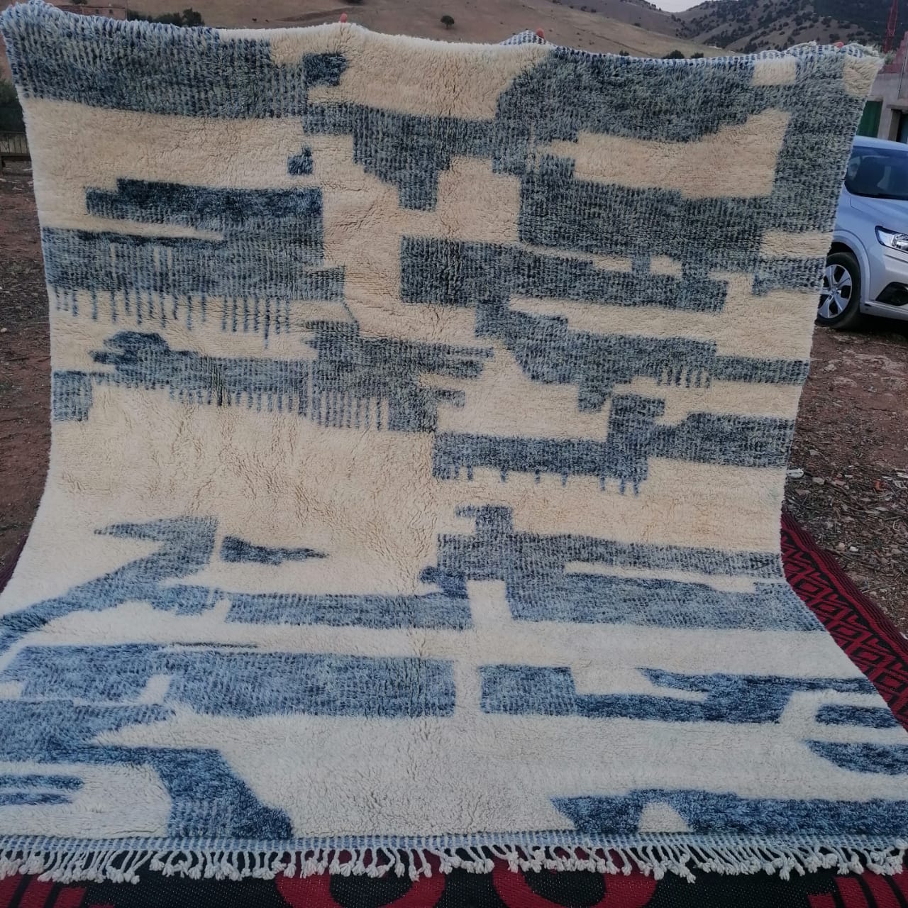 Ivory Moroccan rug with abstract blue-grey fragmented block and mosaic pattern across the field
