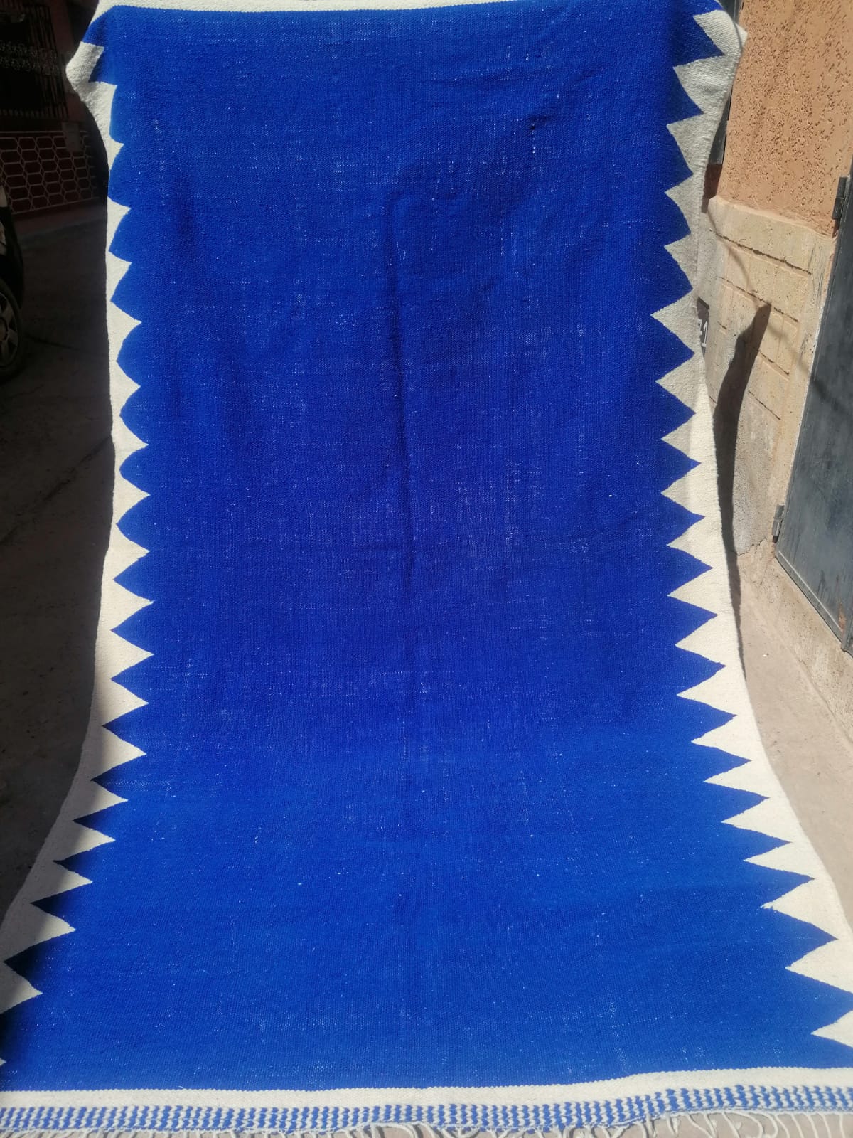 Cobalt blue flat-woven Moroccan kilim with bold ivory zigzag border running full length
