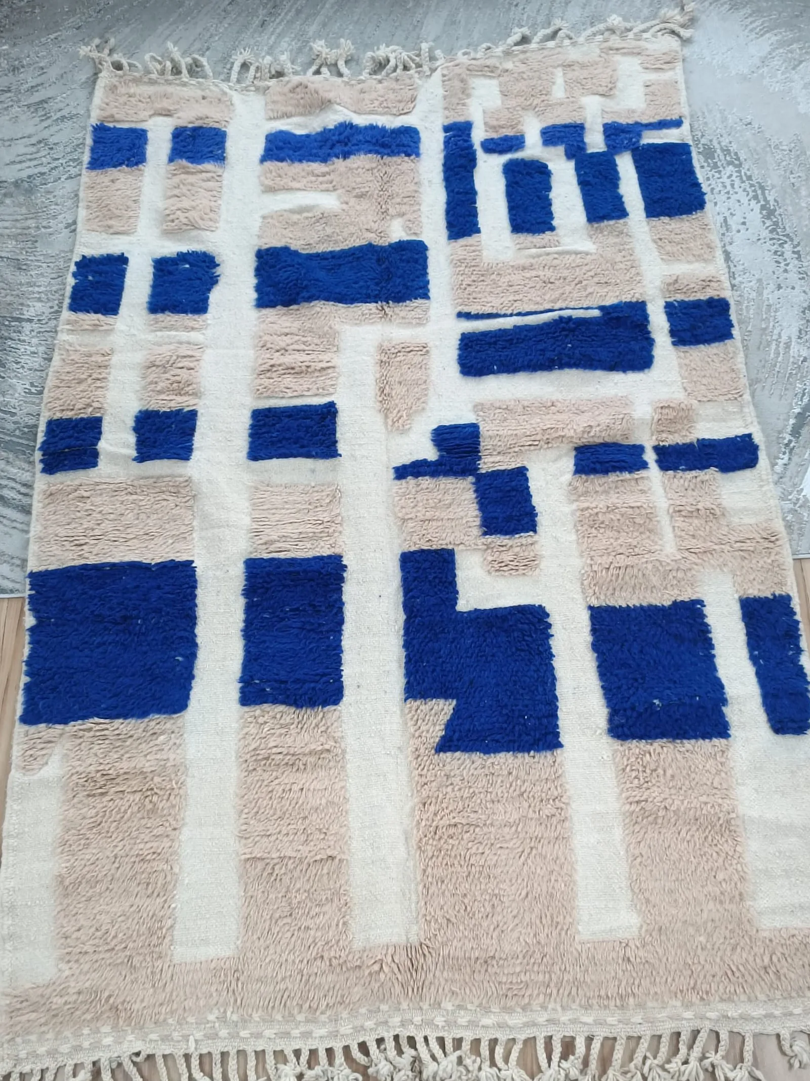 Cream and beige contemporary Moroccan rug with scattered royal blue rectangles