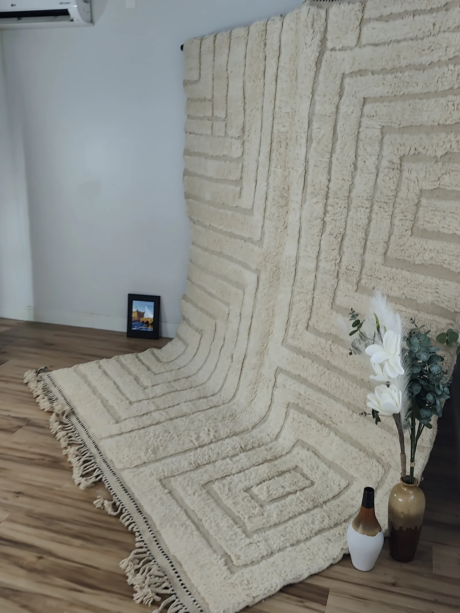 Latifa — hung from a rail and cascading onto the floor beside vases, Contemporary Moroccan rug from Morocco, 271 × 200 cm, view 15 of 21