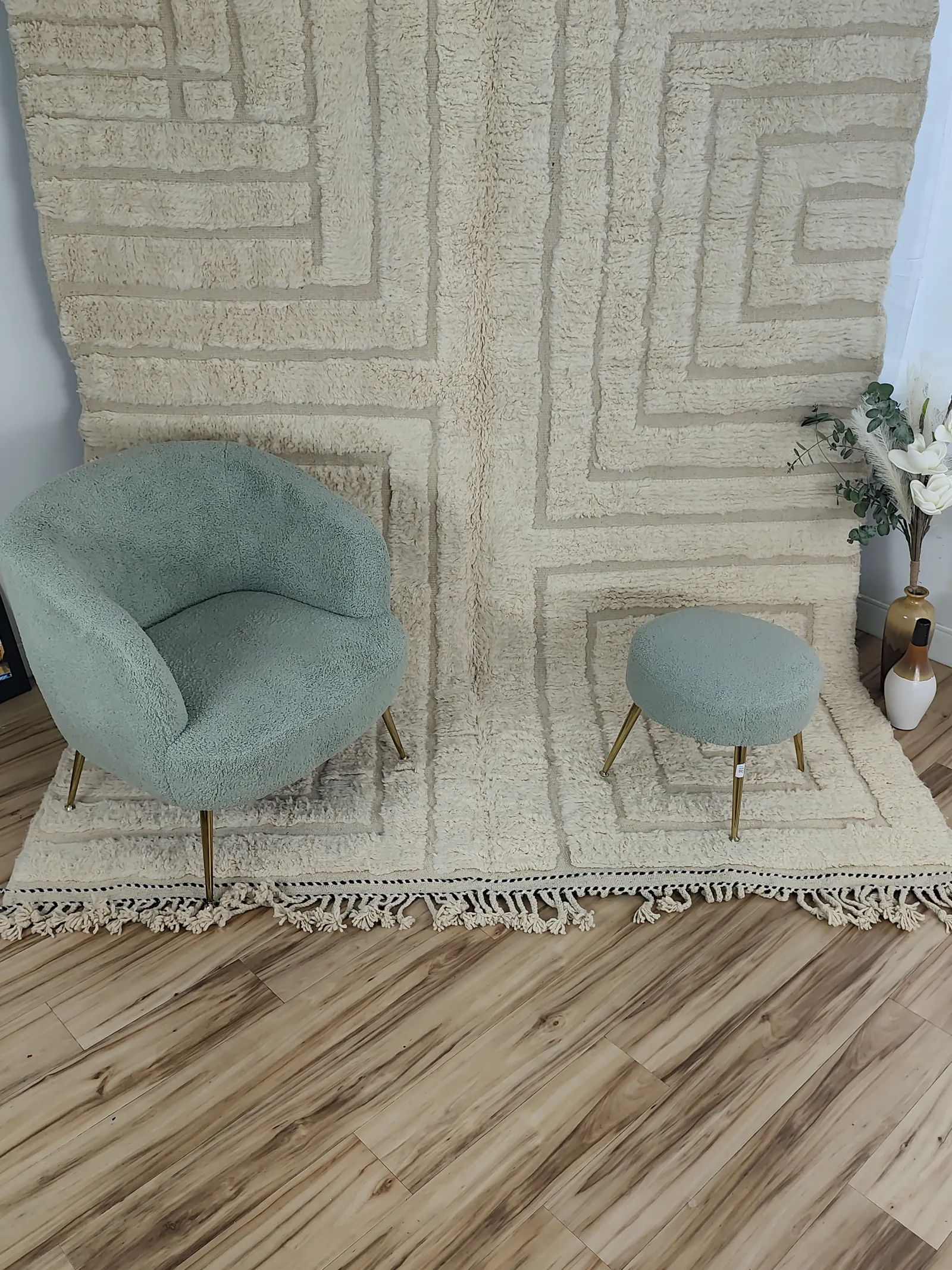 Latifa — a boucle chair and stool on the rug, seen wide, the hem carries a delicate black-and-white dash accent, 271 × 200 cm, view 17 of 21