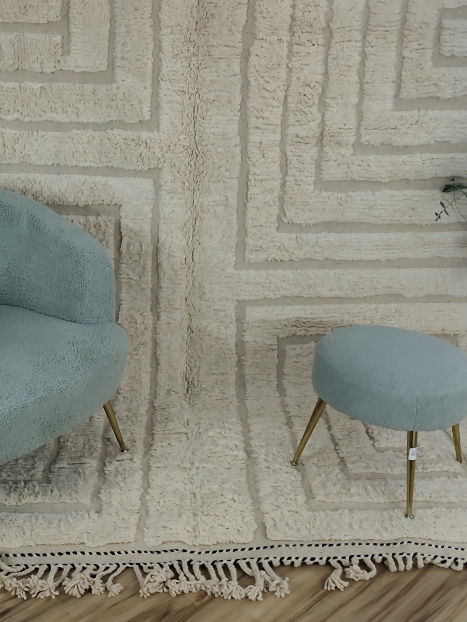 Latifa — a boucle chair and stool at the edge of the carved field, ivory Contemporary rug, medium pile, sculptured/carved, view 11 of 21