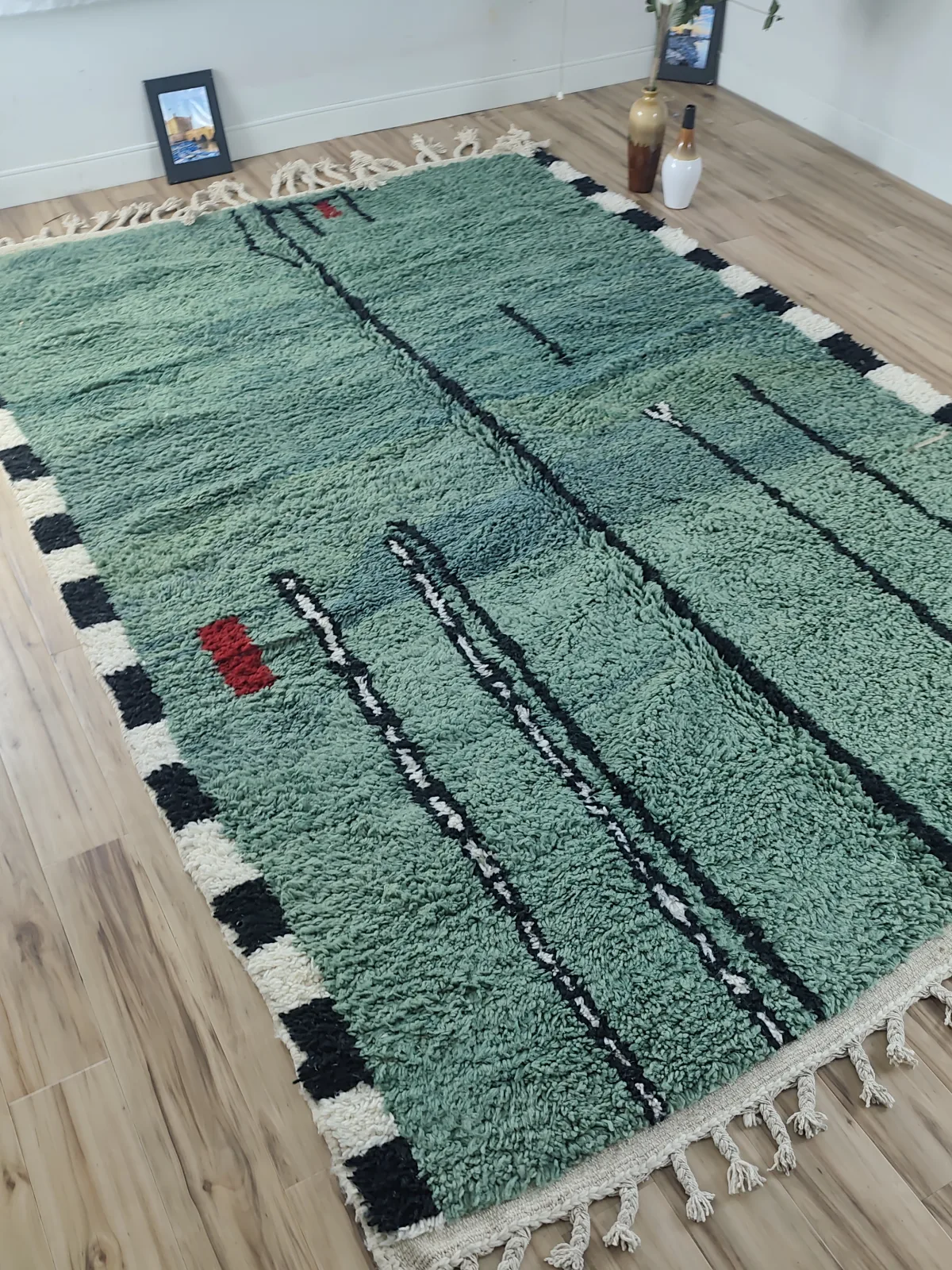 Forest green contemporary Moroccan rug with black abstract line art and checkerboard border