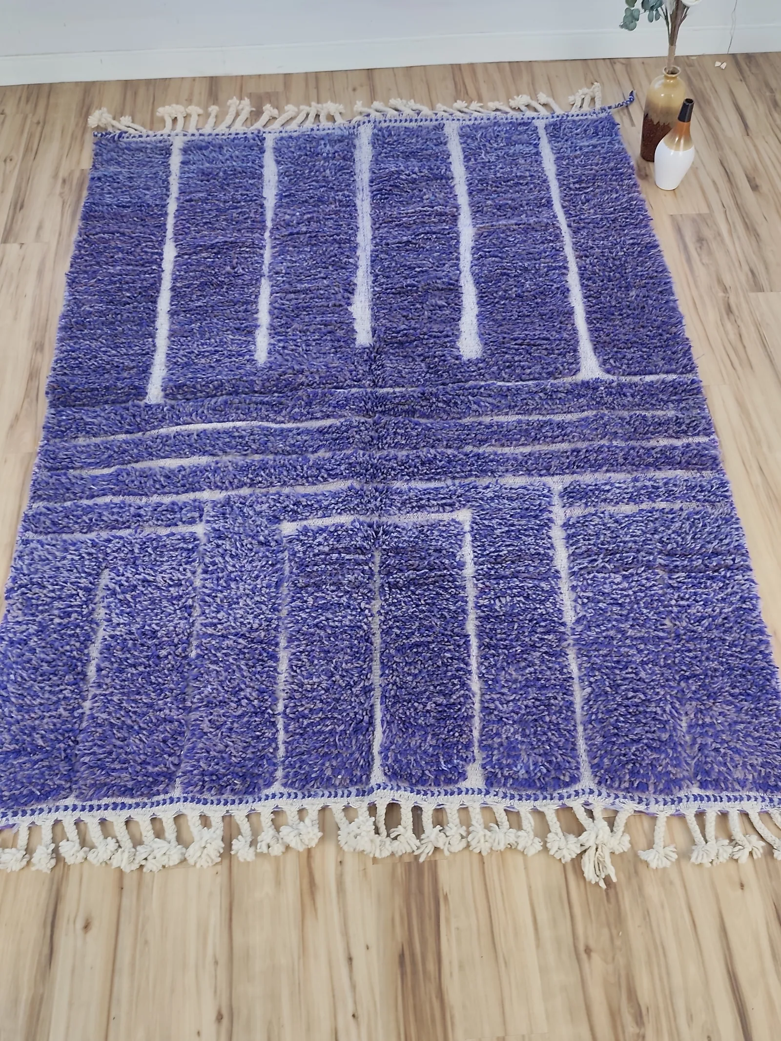 Cobalt blue Beni Ourain rug with white rectangular grid motifs across the full plush field