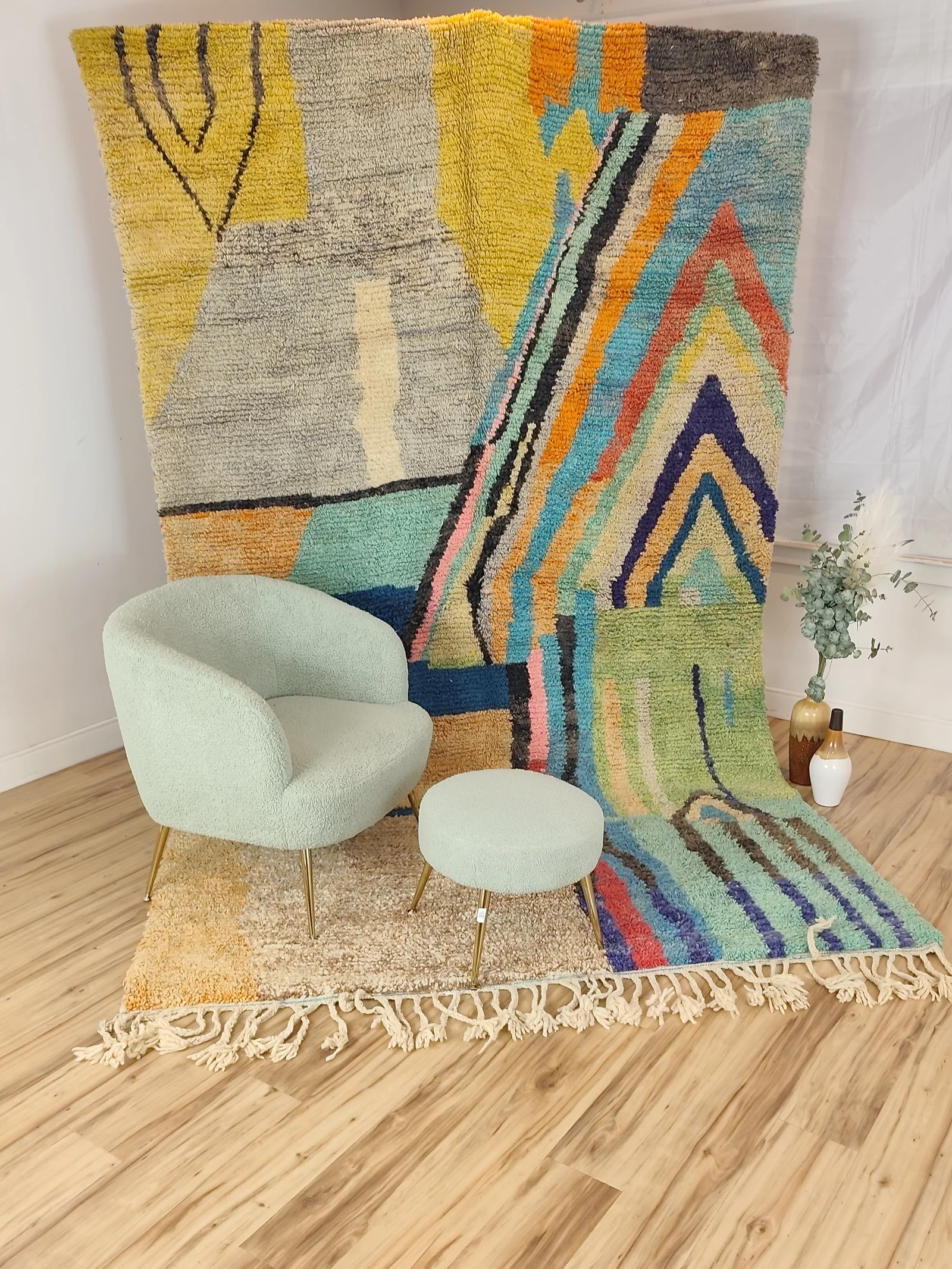 Soukaina — a chair and stool against the hung rug, close in, modern and painterly, unlike any other piece, high pile, view 16 of 20