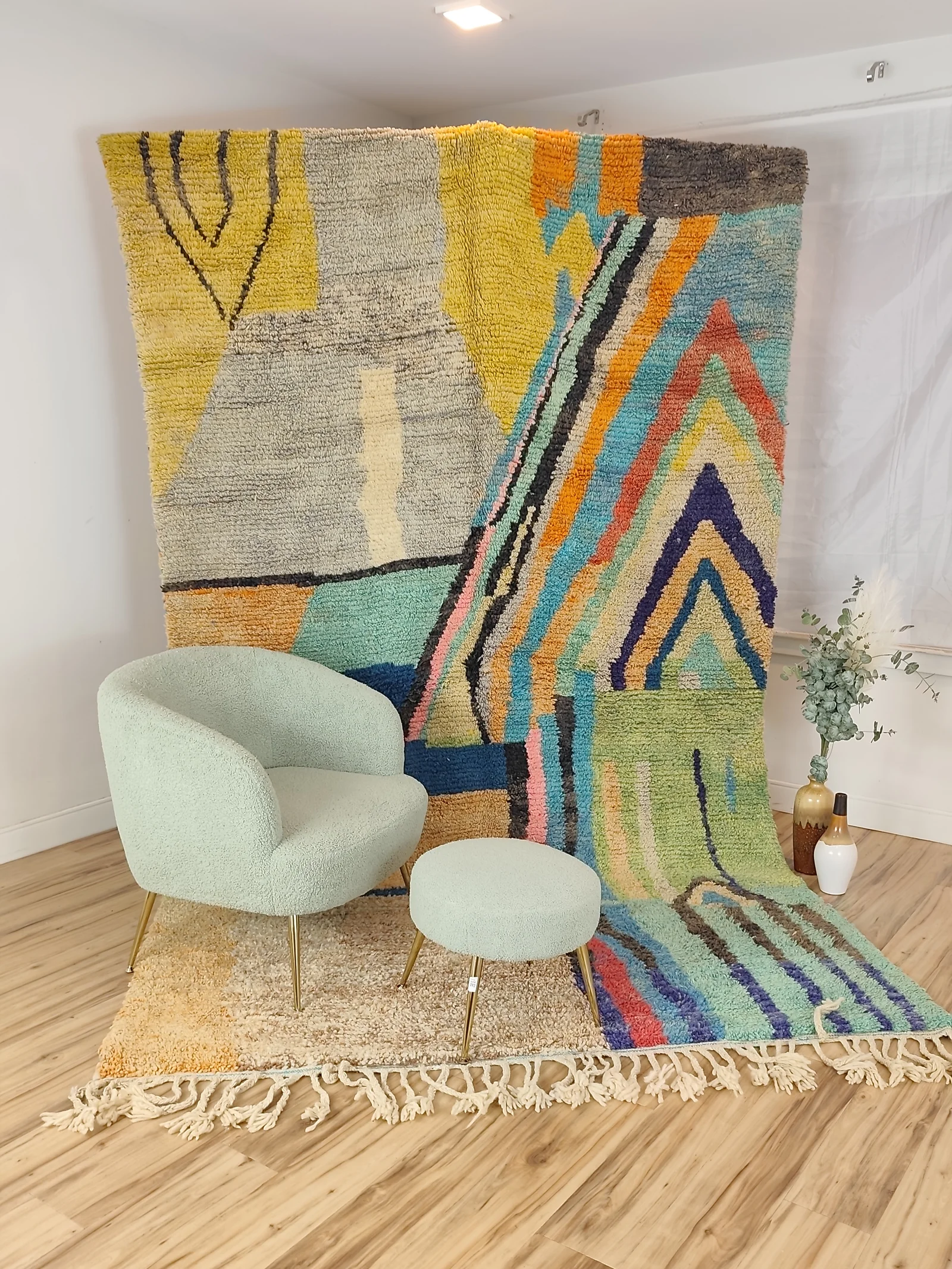 Soukaina — a boucle chair and stool before the hung rug, seen wide, modern and painterly, unlike any other piece, Boujaad weave, view 17 of 20