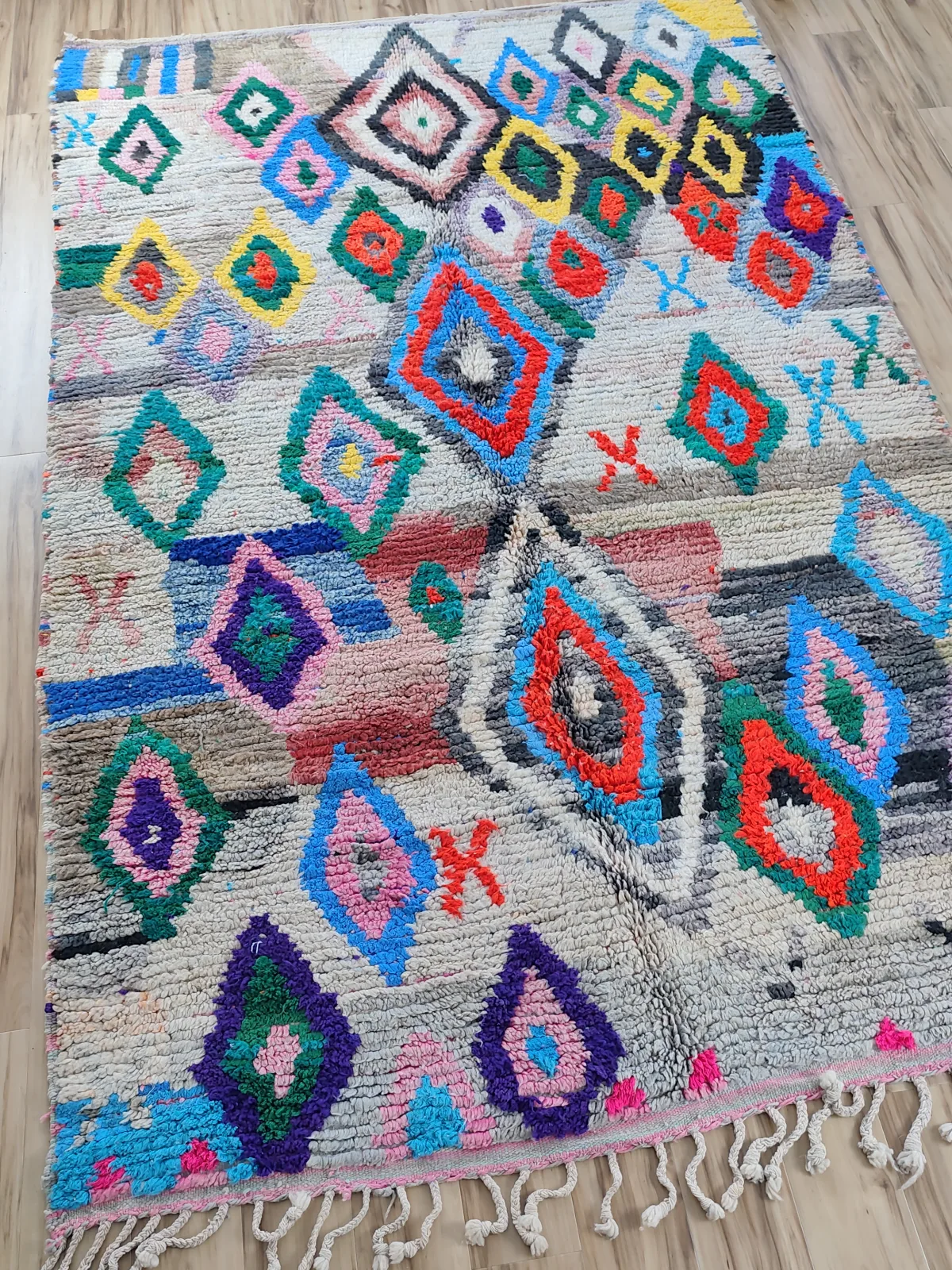 Vivid tribal Boujaad rug with diamond and eye motifs in red, pink, orange and teal