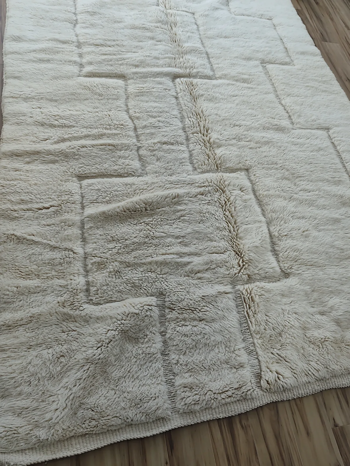 Ivory Beni Ourain rug with carved stepped channels interlocking along a raised center ridge