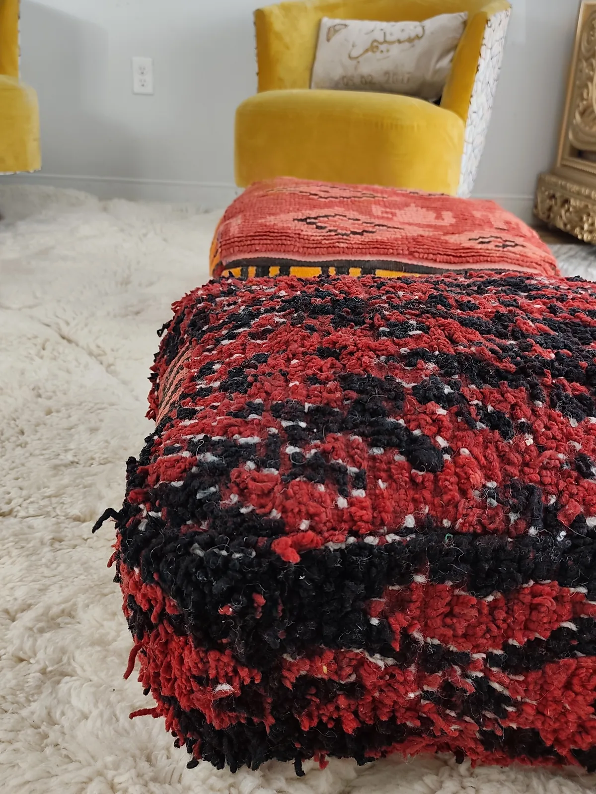 Kahina — red & black boucherouite pouf, angled view showing the depth of the pile, view 2 of 7