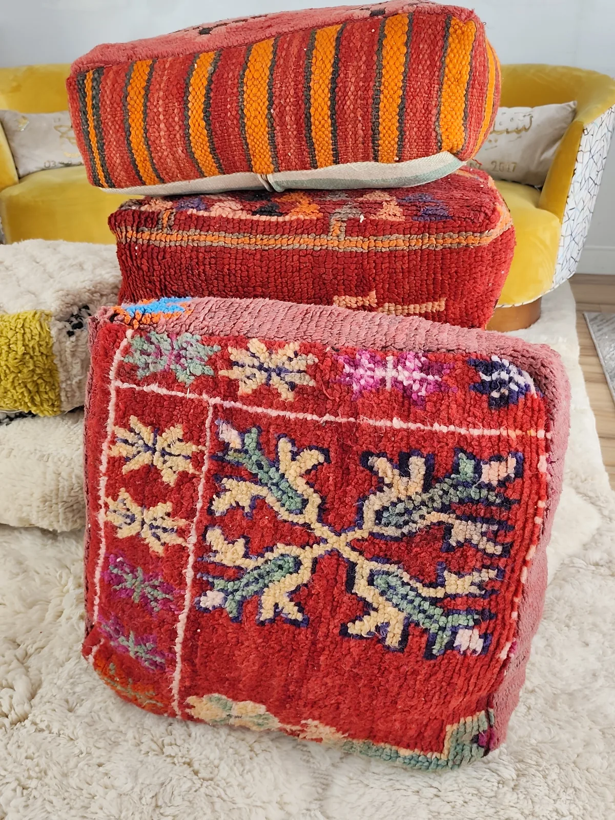 Tinhinan — botanical crimson pouf, styled beside a mustard armchair, view 6 of 8